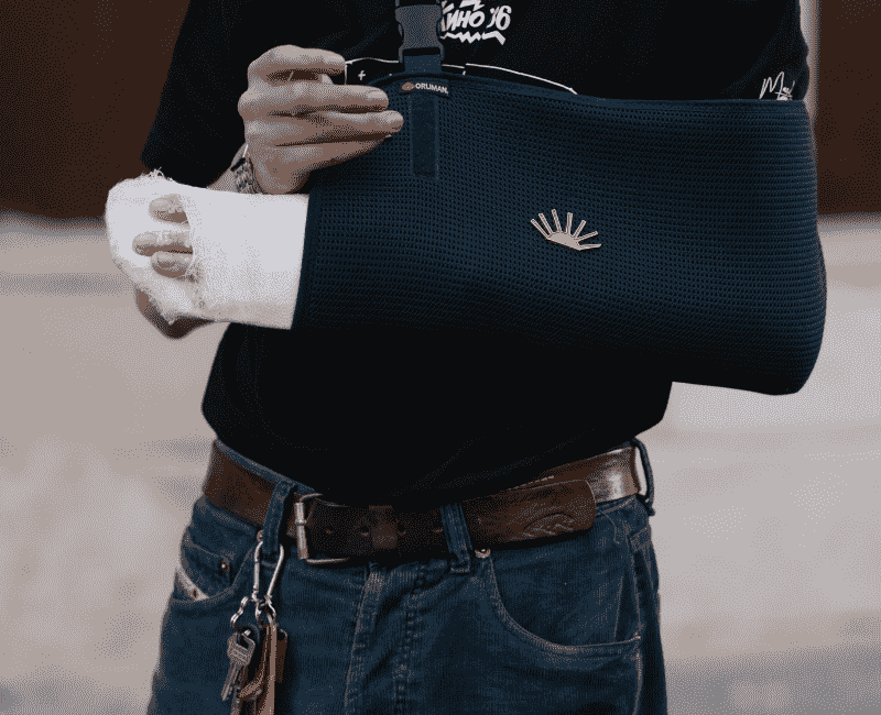 Man with injured arm in sling