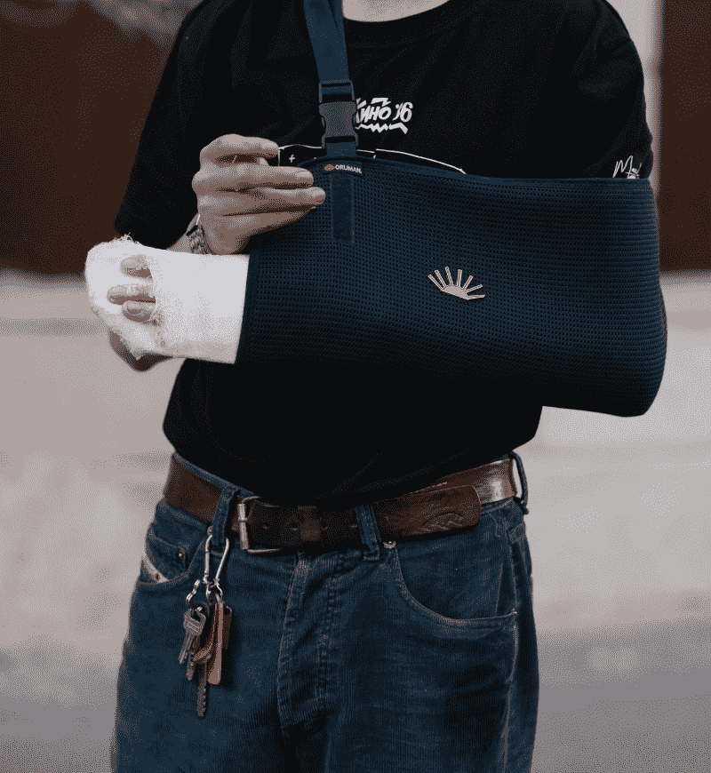Man with injured arm in sling