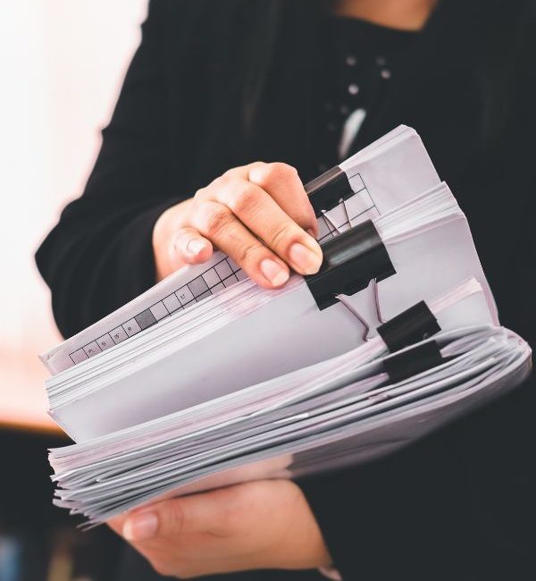 Hands holding stacks of sorted papers